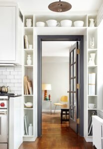 black-door-and-trim-surrounded-by-built-in-shelving-via-Remodelista